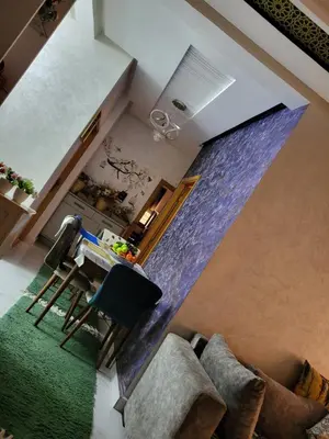 an overhead view of a living room with a table and chairs at Belle appartement in Meknès