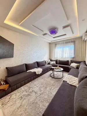 a living room with a couch and a table at Chic & Cozy Apartment in Tangier in Oulad Akkou