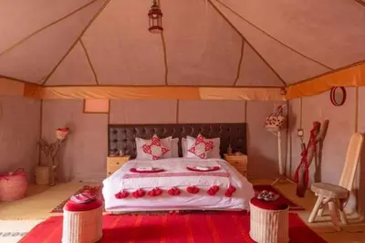 a bedroom with a large bed in a tent at Overnight luxury camp merzouga in Merzouga