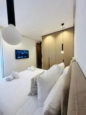 a bedroom with a large white bed with white pillows at 1 Bedroom Apartment Rooftop Pool Marrakech in Oulad Akkou