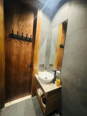 a bathroom with a sink and a mirror at 1 Bedroom Apartment Rooftop Pool Marrakech in Oulad Akkou
