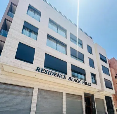a building with the sign for resilience black hills at 1 Bedroom Apartment Rooftop Pool Marrakech in Oulad Akkou
