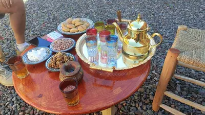 a table with a tea kettle and bowls of food at Casa caram in Hassilabied