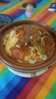 a pan filled with food on top of a table at Casa caram in Hassilabied