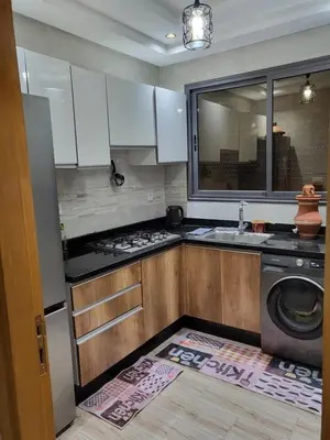 a kitchen with a sink and a washing machine at Appartement de luxe in Meknès