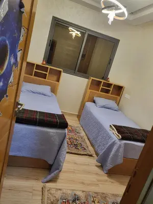 a bedroom with two beds and a window at Appartement de luxe in Meknès