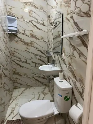 a bathroom with a toilet and a sink at Chambre d'hôtes dans luxueuse villa avec piscine in Had Abdallah Rhiat