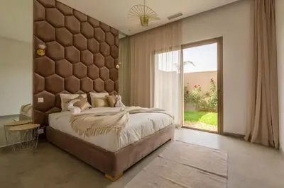 a bedroom with a large bed and a large window at Villa Seyana 3 sans vis a vis, Piscine Chauffee in Marrakech