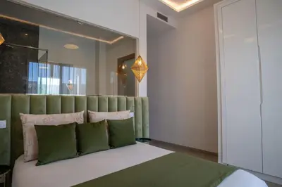 a bedroom with a large bed with green pillows at Villa Seyana 3 sans vis a vis, Piscine Chauffee in Marrakech