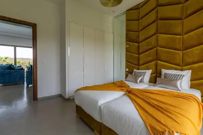 a bedroom with a large bed with a large headboard at Villa Seyana 3 sans vis a vis, Piscine Chauffee in Marrakech