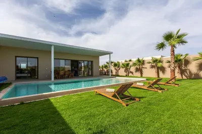 a house with a swimming pool next to a yard at Villa Seyana 3 sans vis a vis, Piscine Chauffee in Marrakech