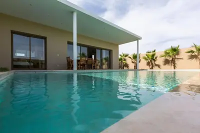 a swimming pool in front of a house at Villa Seyana 3 sans vis a vis, Piscine Chauffee in Marrakech