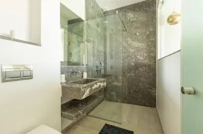 a bathroom with a stone sink and a shower at Villa Seyana 4 sans vis a vis, Piscine Chauffee in Marrakech