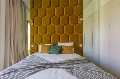 a bedroom with a large bed with a yellow headboard at Villa Seyana 4 sans vis a vis, Piscine Chauffee in Marrakech
