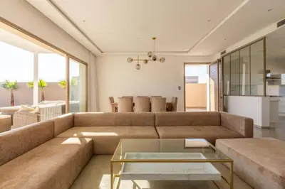 a living room with a couch and a table at Villa Seyana 6 Zero vis a vis Piscine chauffee in Marrakech