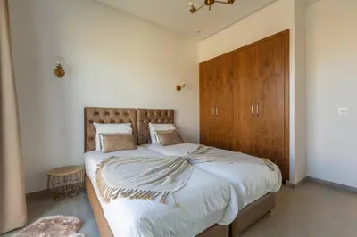 a bedroom with a large bed with a wooden headboard at Villa Seyana 6 Zero vis a vis Piscine chauffee in Marrakech