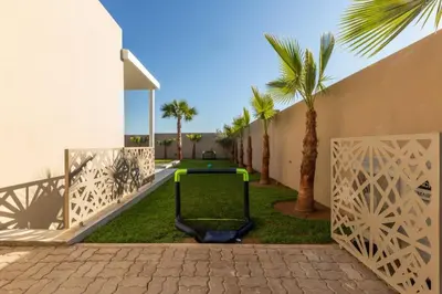 a golf cart in a yard next to a building at Villa Seyana 6 Zero vis a vis Piscine chauffee in Marrakech