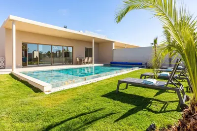 a backyard with a swimming pool and a house at Villa Seyana 7 Zero Vis a Vis, Piscine Chauffee in Gzoula