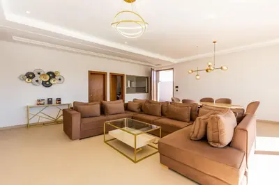 a living room with a couch and a table at Villa Seyana 8 Zero Vis a Vis Piscine Chauffee in Gzoula