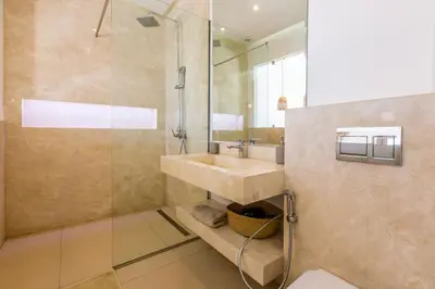 a bathroom with a sink and a shower at Villa Seyana 8 Zero Vis a Vis Piscine Chauffee in Gzoula