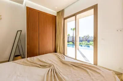 a bedroom with a bed and a large window at Villa Seyana 8 Zero Vis a Vis Piscine Chauffee in Gzoula