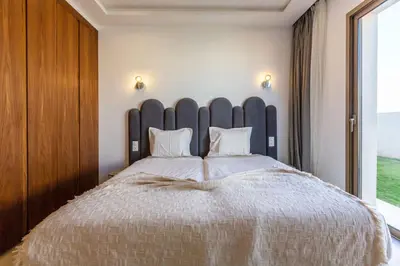 a bedroom with a large bed with a large headboard at Villa Seyana 8 Zero Vis a Vis Piscine Chauffee in Gzoula