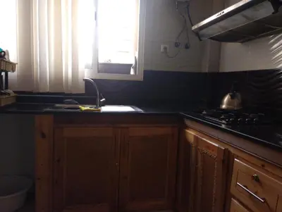 a kitchen with a sink and a stove at Appartement bien équipé in Ifrane