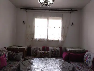 a living room with a couch and a window at Appartement bien équipé in Ifrane