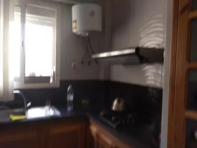 a kitchen with a stove and a window at Appartement bien équipé in Ifrane