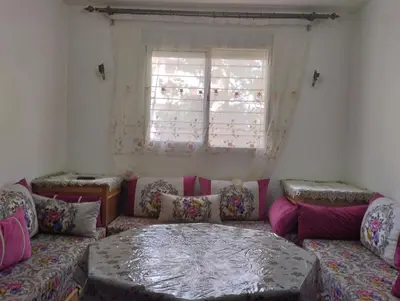 a living room with a couch and a window at Appartement bien équipé in Ifrane