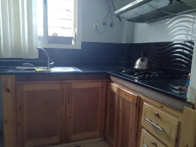 a kitchen with a sink and a stove top oven at Appartement bien équipé in Ifrane
