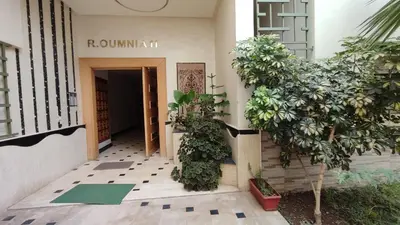 an entrance to a building with plants in front of it at Good life in Fès