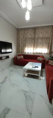 a living room with a couch and a table at Good life in Fès