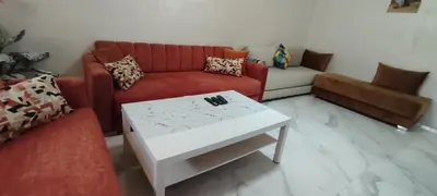 a living room with a couch and a coffee table at Good life in Fès