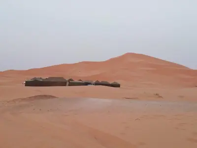 a building in the middle of a desert at chez zakaria luxury tent camp merzouga in Merzouga