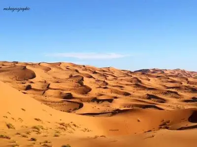 a sand dune in the middle of a desert at chez zakaria luxury tent camp merzouga in Merzouga