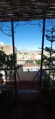 a room with a window with a view of a beach at The hostel with terrace view in Fès
