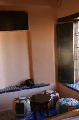 a room with three stools and a window at The hostel with terrace view in Fès