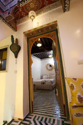 an ornate doorway to a room with a bed at Riad Qobbat Zaouïa in Fès