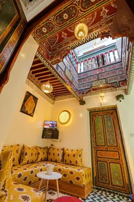a living room with a couch and a ceiling at Riad Qobbat Zaouïa in Fès