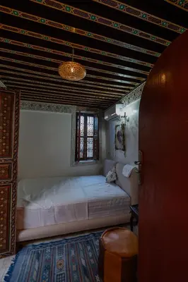 a bedroom with a large bed in a room at Riad Qobbat Zaouïa in Fès