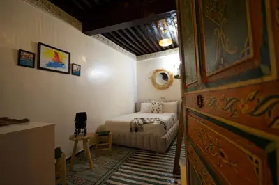 a bedroom with a bed and a couch in a room at Riad Qobbat Zaouïa in Fès