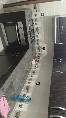 a kitchen counter with a row of sinks in a kitchen at 2 bedroom apartment for rent in Meknès