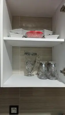a shelf with three glass vases on it at 2 bedroom apartment for rent in Meknès