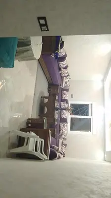 a room with a staircase with chairs and a window at 2 bedroom apartment for rent in Meknès