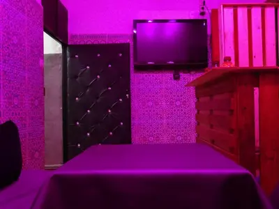 a purple room with a bed and a tv at Youth housing EL HABIB in Fès