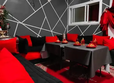 a room with red and black tables and a couch at Youth housing EL HABIB in Fès