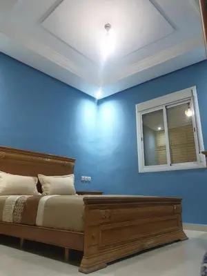 a blue bedroom with a bed and a window at Charmant appart proche Ain Asserdoun Béni Mellal in Oulad Akkou
