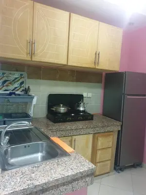 a kitchen with a sink and a stove and a refrigerator at Charmant appart proche Ain Asserdoun Béni Mellal in Oulad Akkou