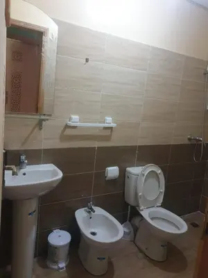 a bathroom with a toilet and a sink at Charmant appart proche Ain Asserdoun Béni Mellal in Oulad Akkou